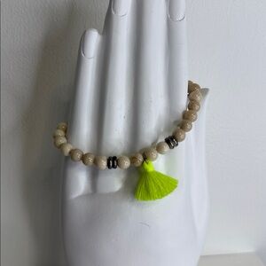 T.JAZELLE retired bracelet with light tan stones & a neon green tassel